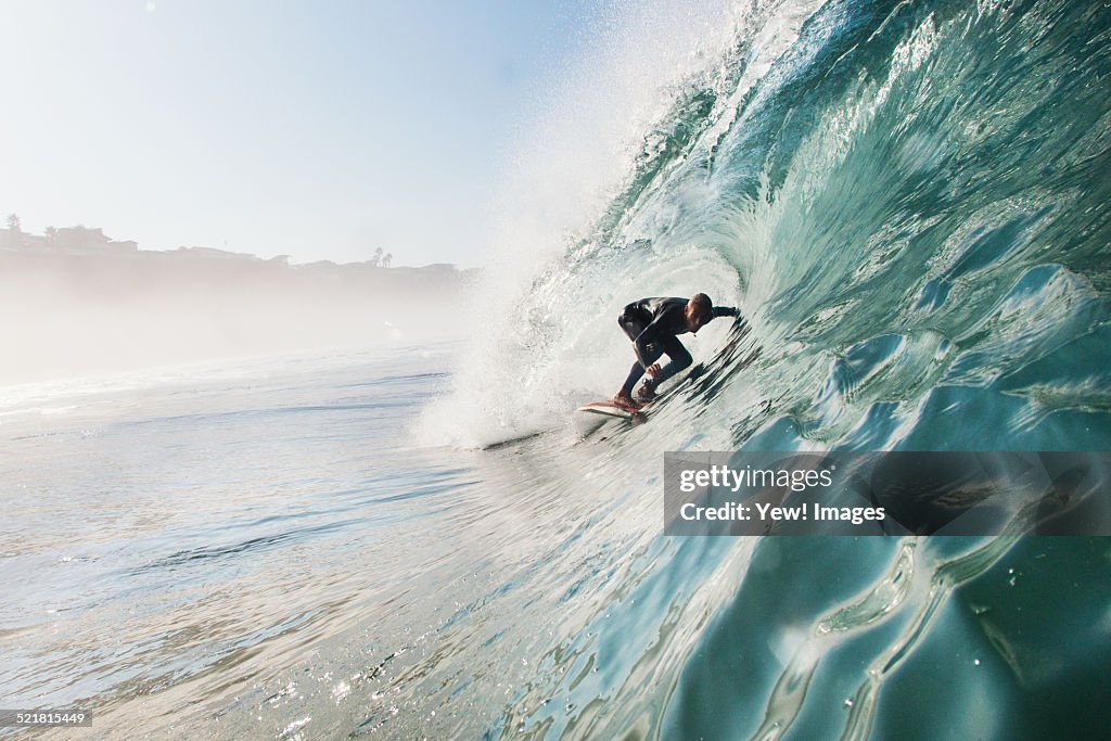 Mid adult man surfing rolling wave, Leucadia, California, USA