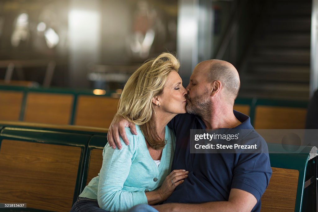 Mature couple kissing in passenger ferry