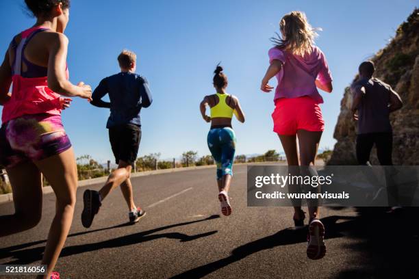 team of athletes running outdoors on summer - running stock pictures, royalty-free photos & images