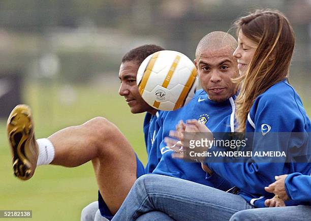 Brazilian striker Ronaldo Nazario fidgets with a ball and his girlfriend, Brazilian model Daniele Cicarelli, during a training session with the...
