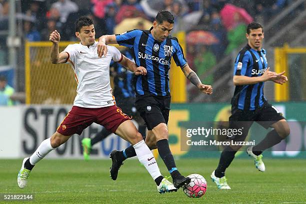 Marco Borriello of Atalanta BC competes for the ball with Diego Perotti of AS Roma during the Serie A match between Atalanta BC and AS Roma at Stadio...