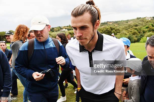 Real Madrid and Wales footballer Gareth Bale looks on as he follows Sergio Garcia's group during the final round on day four of the Open de Espana at...