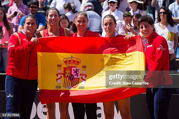 Captain Conchita Martinez, Garbine Muguruza, Sara Sorribes, Anabel Medina and Carla Suarez Navarro of Spain celebrate defeating Italy during day two...