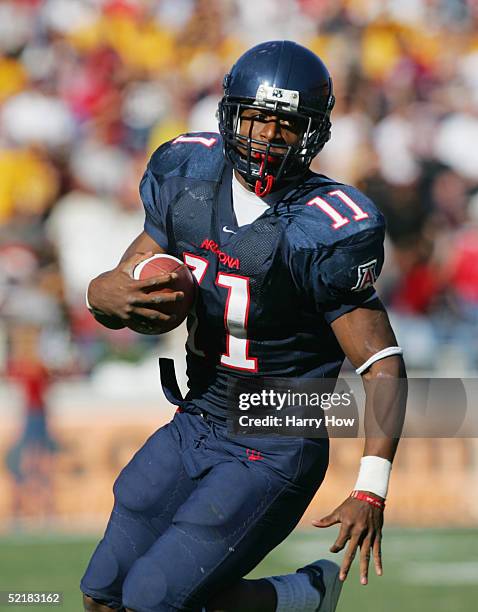 Mike Bell of the Arizona Wildcats runs the ball during the game against the Arizona State Sun Devils at Arizona Stadium on November 26, 2004 in...