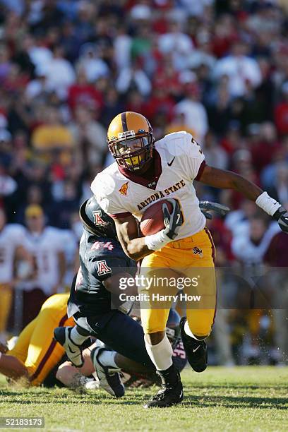 Rudy Burgess of the Arizona State Sun Devils runs the ball during the game against the Arizona Wildcats at Arizona Stadium on November 26, 2004 in...