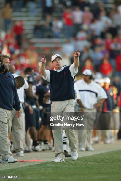 Head coach Mike Stoops of the Arizona Wildcats walks the sideline during the game against the Arizona State Sun Devils at Arizona Stadium on November...