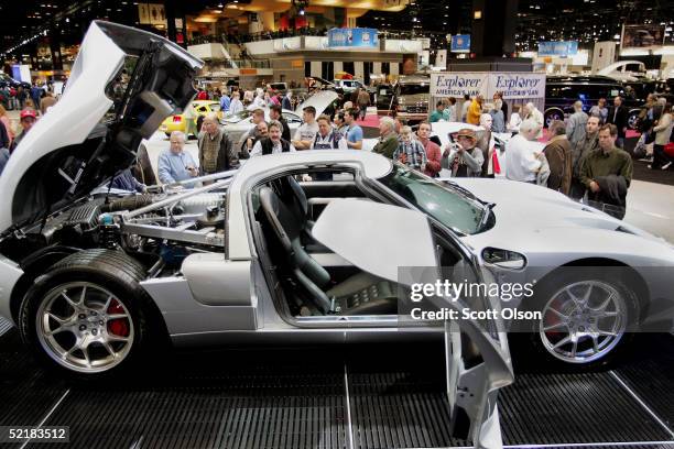 Spectators look over the 550 horsepower 2005 Ford GT at the Chicago Auto Show on February 11, 2005 in Chicago, Illinois. The Auto Show opened to the...