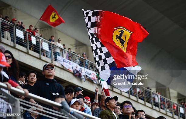 Fans hold Ferrari's flag during the Formula One Grand Prix of China at Shanghai International Circuit on April 17, 2016 in Shanghai, China.
