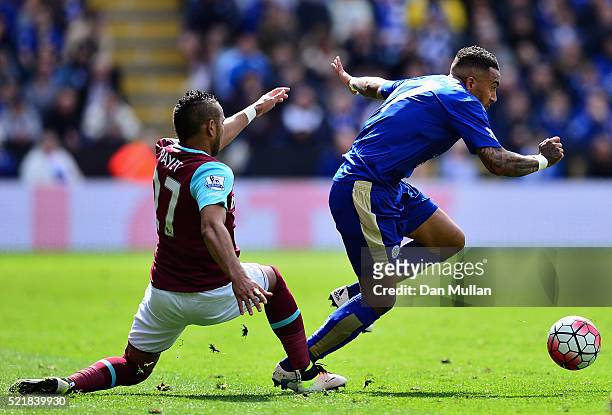 Danny Simpson of Leicester City skips past the tackle of Dimitri Payet of West Ham United during the Barclays Premier League match between Leicester...