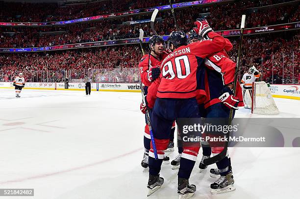 Jay Beagle of the Washington Capitals celebrates with his teammates after scoring a third period goal against the Philadelphia Flyers in Game One of...