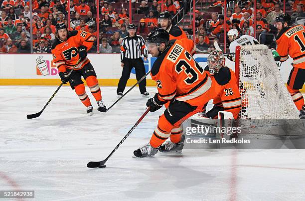 Mark Streit of the Philadelphia Flyers skates the puck alongside teammates Sean Couturier, Steve Mason, Nick Schultz and Ryan White of the Pittsburgh...