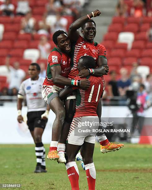 Kenya's Robert Aringo celebrates with teammates after defeating Fiji in the cup final at the Singapore Sevens rugby tournament on April 17, 2016. /...