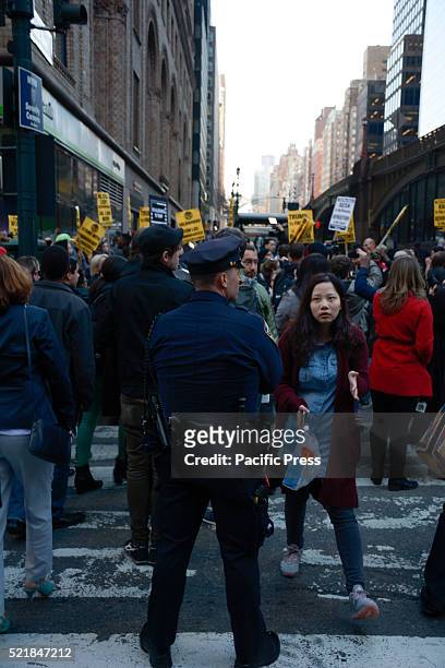 Officer directing protesters in the crosswalk at "Anti Trump Rally" outside of the Grand Hyatt. The New York state Republican party held a gala in...