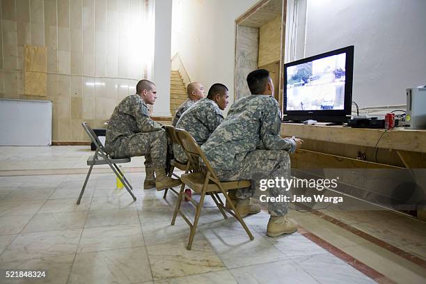 soldiers playing videogames inside mahmoon palace, originally built to celebrate saddam hussein's birthdays, tikrit - iraq tikrit stock pictures, royalty-free photos & images