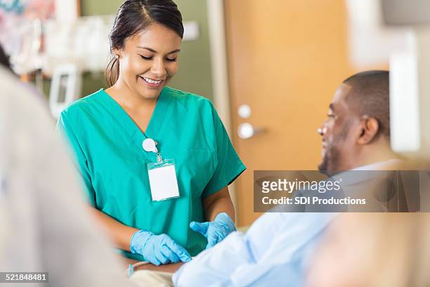 nice hospital phlebotomist taking a sample from a patient - blood stock pictures, royalty-free photos & images