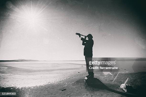 connoisseur looks through spyglass in the dessert - hand held telescope stock pictures, royalty-free photos & images