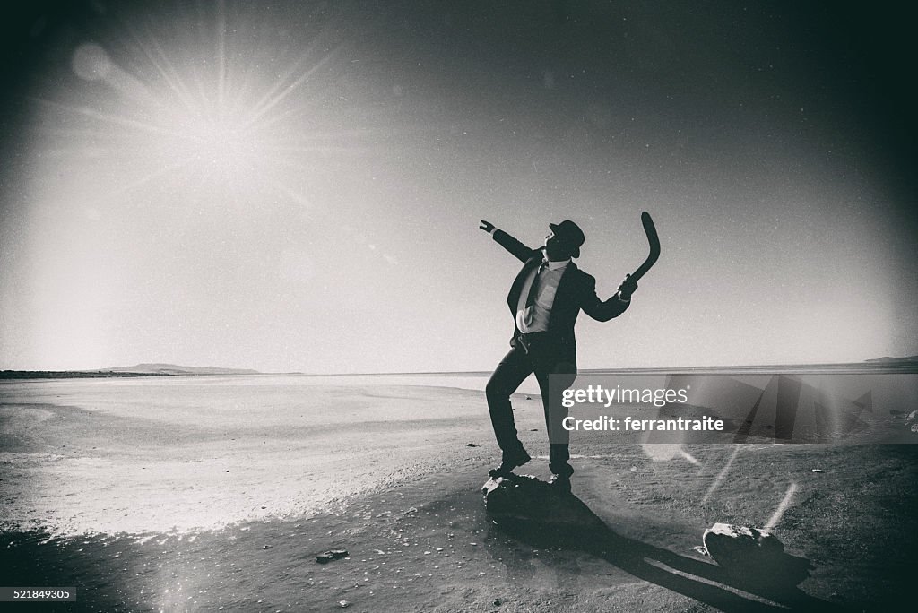 Businessman Tossing a Boomerang to the Sun