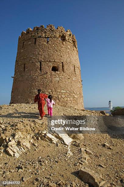 girls walking towards village watchtower - 監視塔 ストックフォトと画像