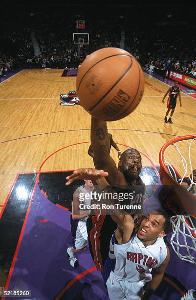 Shaquille O'Neal of the Miami Heat takes the ball to the basket over Loren Woods of the Toronto Raptors during a game at Air Canada Centre on January...