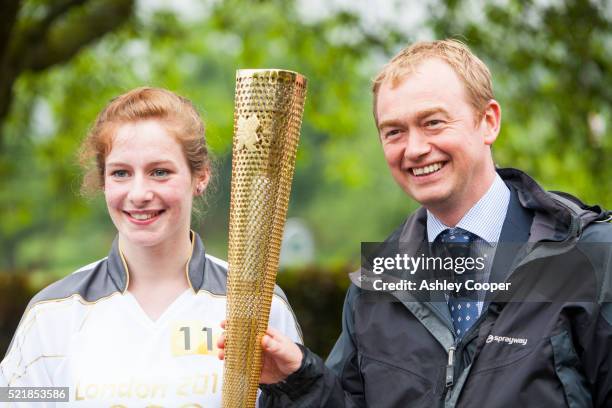 olympic torch bearer with the lib dem mp, tim farron, ambleside, uk. - torch bearer stock pictures, royalty-free photos & images