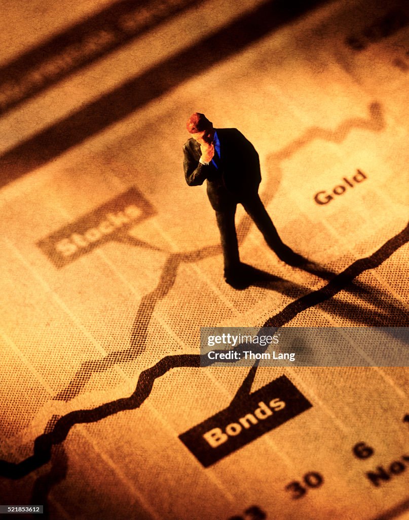 Broker standing on stock graphs