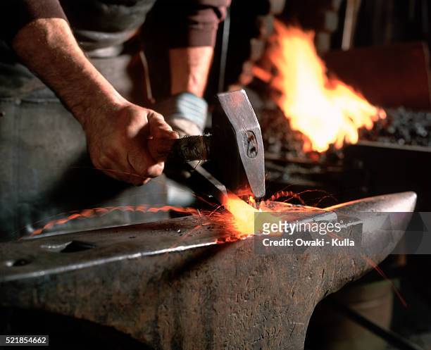 blacksmith at work - anvil stock pictures, royalty-free photos & images