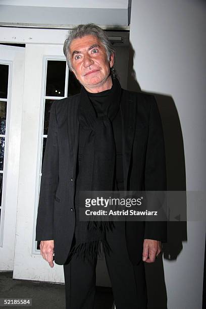 Designer Roberto Cavalli poses for photos in the lobby of the main tent during Olympus Fashion Week Fall 2005 at Bryant Park February 11, 2005 in New...