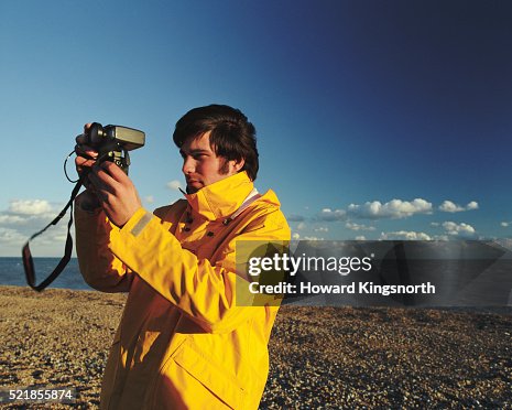 Man Using Camera on Shore Man Using Camera on Shore