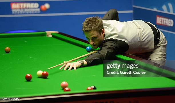 David Gilbert plays a shot against Ronnie O'Sullivan during their first round match of the 2016 Betfred World Snooker Championship at Crucible...