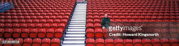 man in empty stadium - one man only stock pictures, royalty-free photos & images