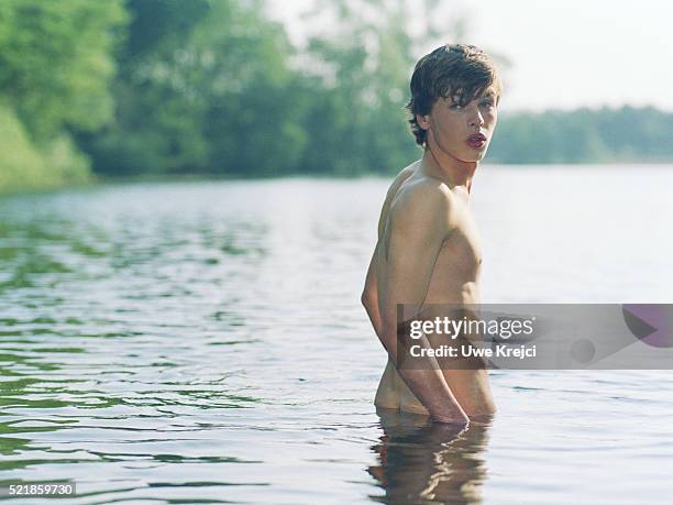 nude boy in lake - man skinny dipping stock pictures, royalty-free photos & images