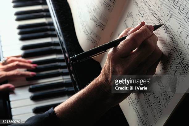hands on piano keyboard - sheet music stock pictures, royalty-free photos & images