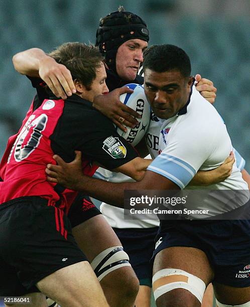 Wycliff Palu of the Waratahs is tackled during the Super 12 trial match between the NSW Waratahs and the Crusaders at Aussie Stadium February 12,...