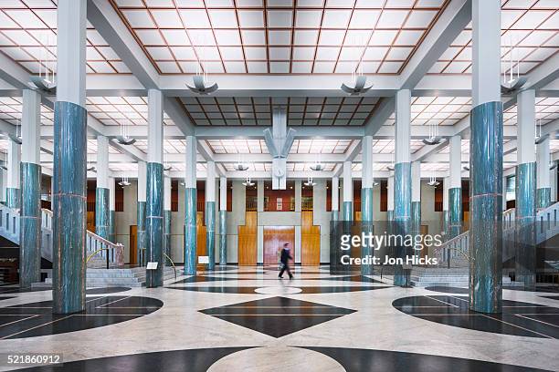 man walking through main foyer in the new parliament house - parlamentsgebäude canberra stock-fotos und bilder