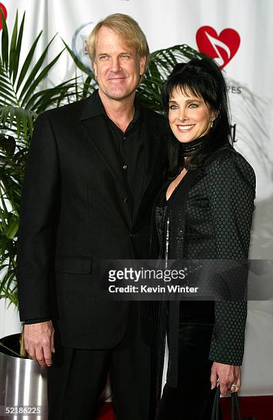 Musician John Tesh and actress Connie Sellecca arrive at the MusiCares 2005 Person of the Year Tribute to Brian Wilson at the Palladium on February...