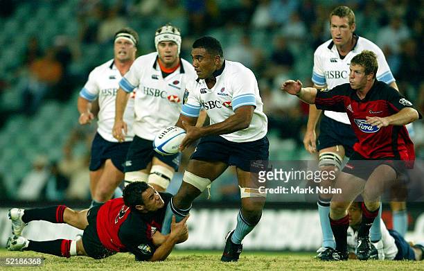 Wycliff Palu of the Waratahs looks to offload during the Super 12 trial match between the NSW Waratahs and the Crusaders at Aussie Stadium February...