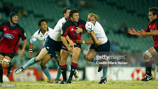 Greg Feek of the Crusaders offloads in action during the Super 12 trial match between the NSW Waratahs and the Crusaders at Aussie Stadium February...
