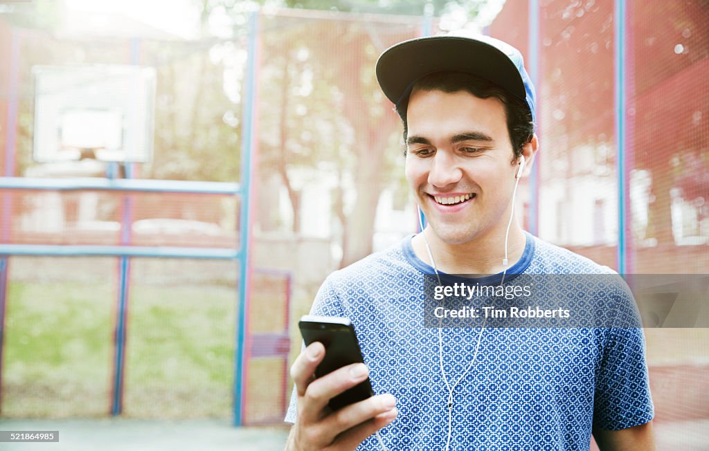 Young man with smart phone and headphones