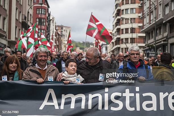 Thousands of people hold banners and flags as they demonstrate in the streets of Bilbao on April 17, 2016 calling for the return of prisoners and...