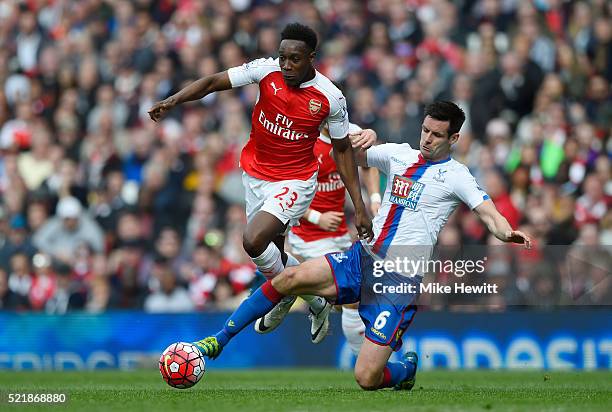 Danny Welbeck of Arsenal is tackled by Scott Dann of Crystal Palace during the Barclays Premier League match between Arsenal and Crystal Palace at...