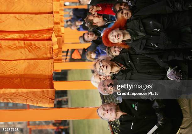 Artists Christo and Jeanne-Claude watches New York City Mayor Michael R. Bloomberg unfurl of the one of the in the "The Gates, Central Park, New...