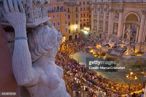 trevi fountain view from santi vincenzo e anastasio church - fontein stockfoto's en -beelden