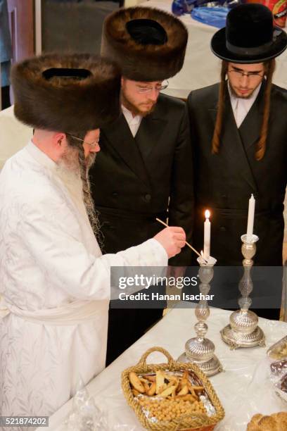 rabbi lighting candles on purim - yom kippur stock pictures, royalty-free photos & images