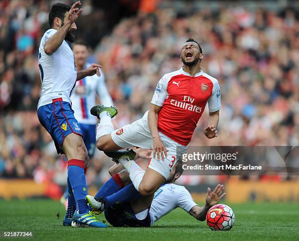 Francis Coquelin of Arsenal is challenged by Mile Jedinak and Yohan Cabaye of Crystal Palace during the Barclays Premier League match between Arsenal...