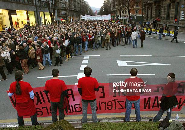 Members of the banned organization Haika hold a banner as thousands of people march against the February 20 European constitutional referendum in...