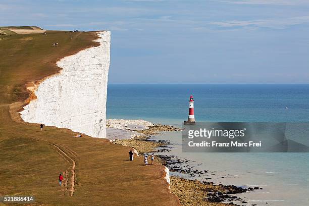 chalk cliffs of the sussex downs and beachy head lighthouse - beachy head stock pictures, royalty-free photos & images