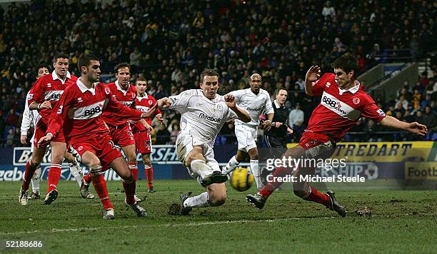 Kevin Davies of Bolton shoots as Chris Riggot of Middlesbrough blocks during the Barclays Premiership match between Bolton Wanderers and...