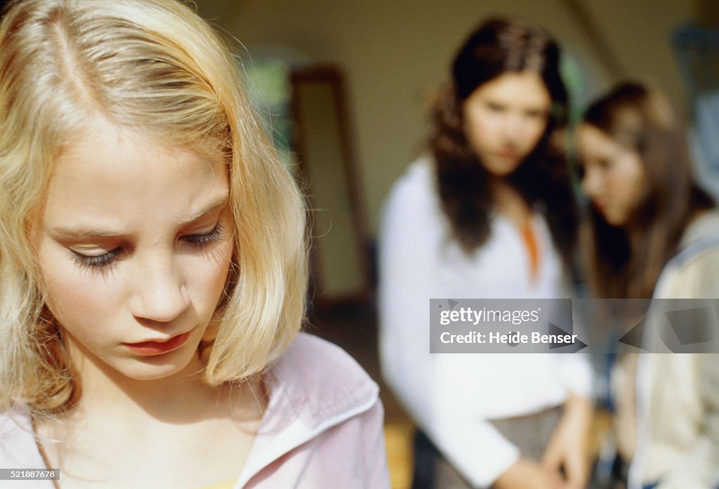 Three teenage girls, blond girl in foreground