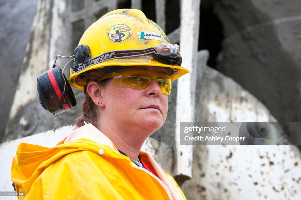 A female Construction worker building new houses in Fort McMurray to house tar sands workers.