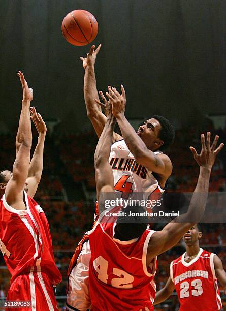 Luther Head of the Illinois Fighting Illini gets off a shot under pressure from Ray Nixon and Alando Tucker of the Wisconsin Badgers on February 12,...